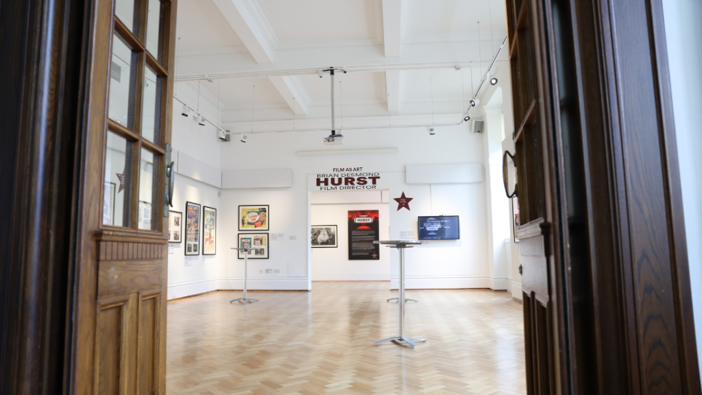 A picture of an exhibition through open doors