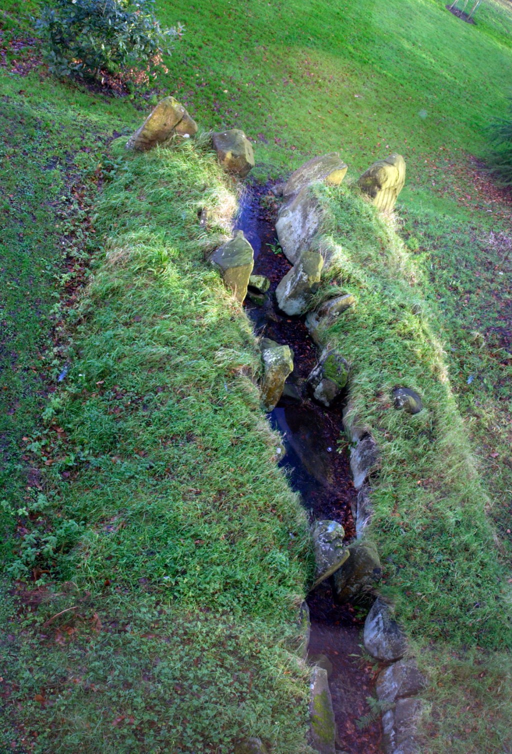 A view of a court tomb from above, with the mounds covered in grass.