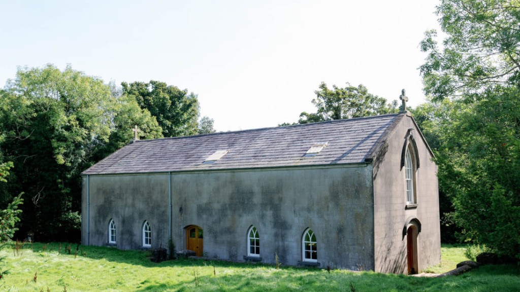 A long church with a crucifix above the door.
