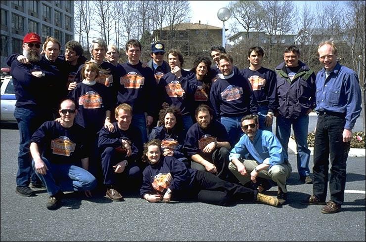 A group of people post for a photograph in an American city.