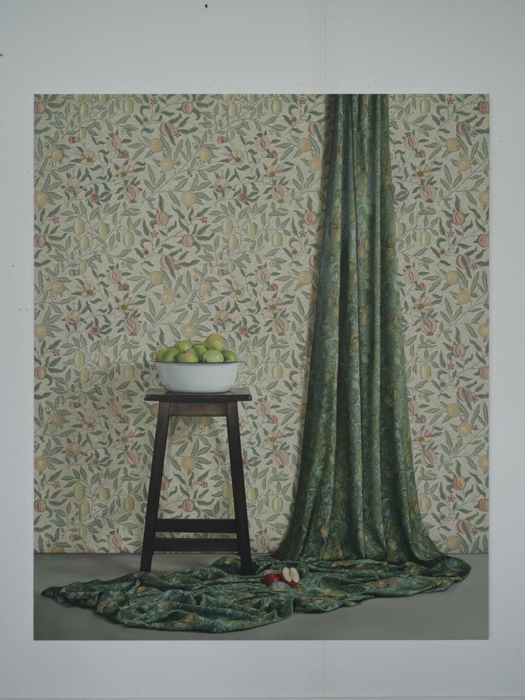 Jennifer Trouton, Original Sin artwork. Pale green pattern wallpaper with a green piece of fabric draping from the wall onto the floor, with a wooden stool and fruit bowl resting on the top.