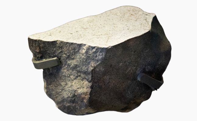 A large meteorite. The rough exterior and polished interior can be seen.