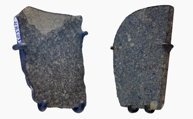 Two small, rectangular cross sections of stony meteorites. 
