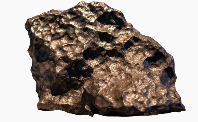 A large chunk of meteorite. It is darkish grey-brown in colour, with a smooth, pitted surface.
