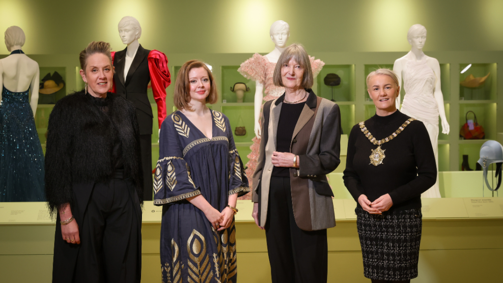 Four women standing in a row, one of them is the Lord Mayor of Belfast wearing her chains.