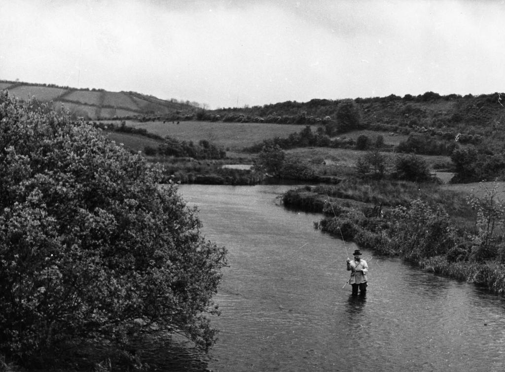 A black and white photo of an angler in Fane River.